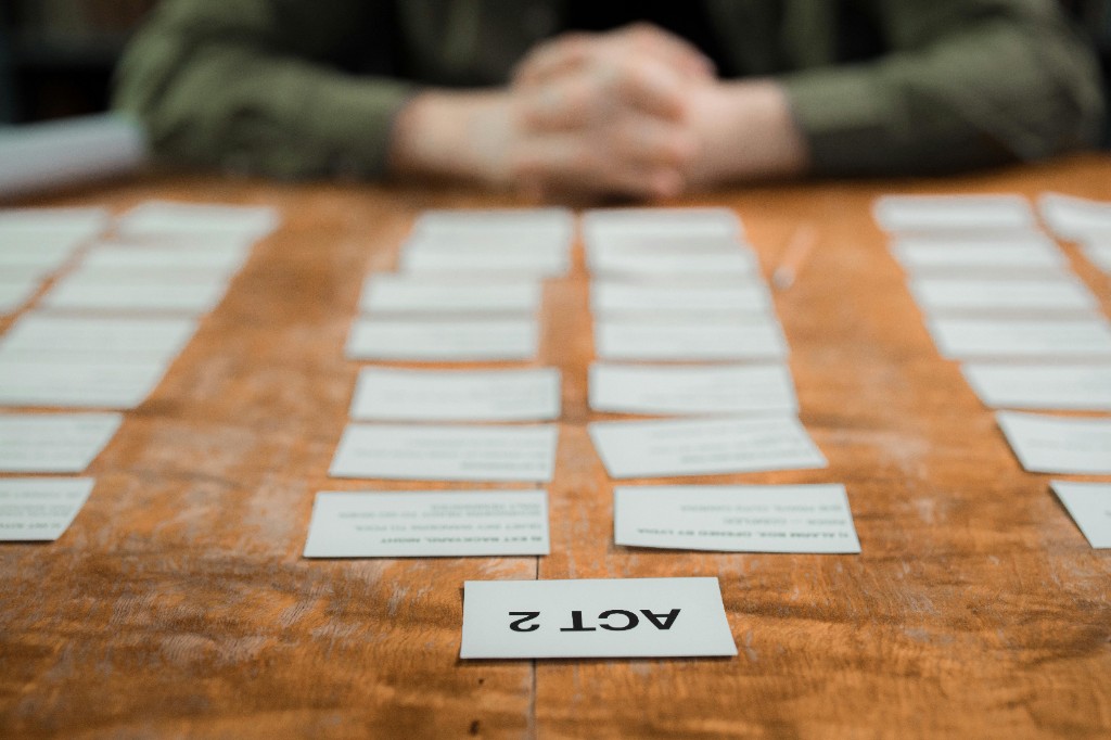 Index cards on a table outlining story structure, ACT 2 in focus